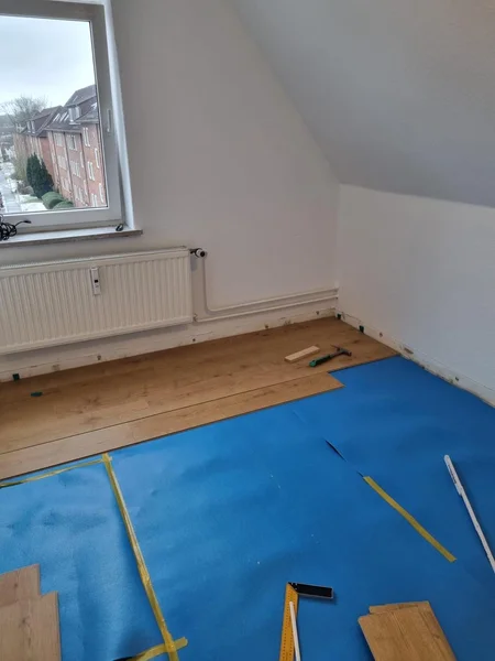Verlegung von Designboden im Dachgeschoss mit Schutzfolie in einem Einfamilienhaus in Kappeln